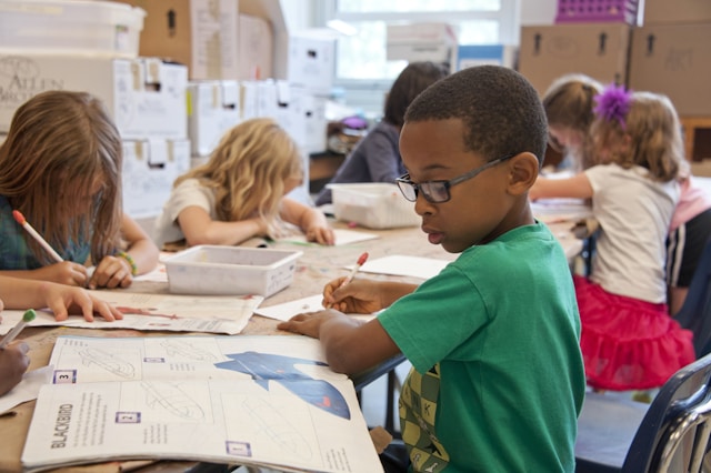 child writes something in a notebook